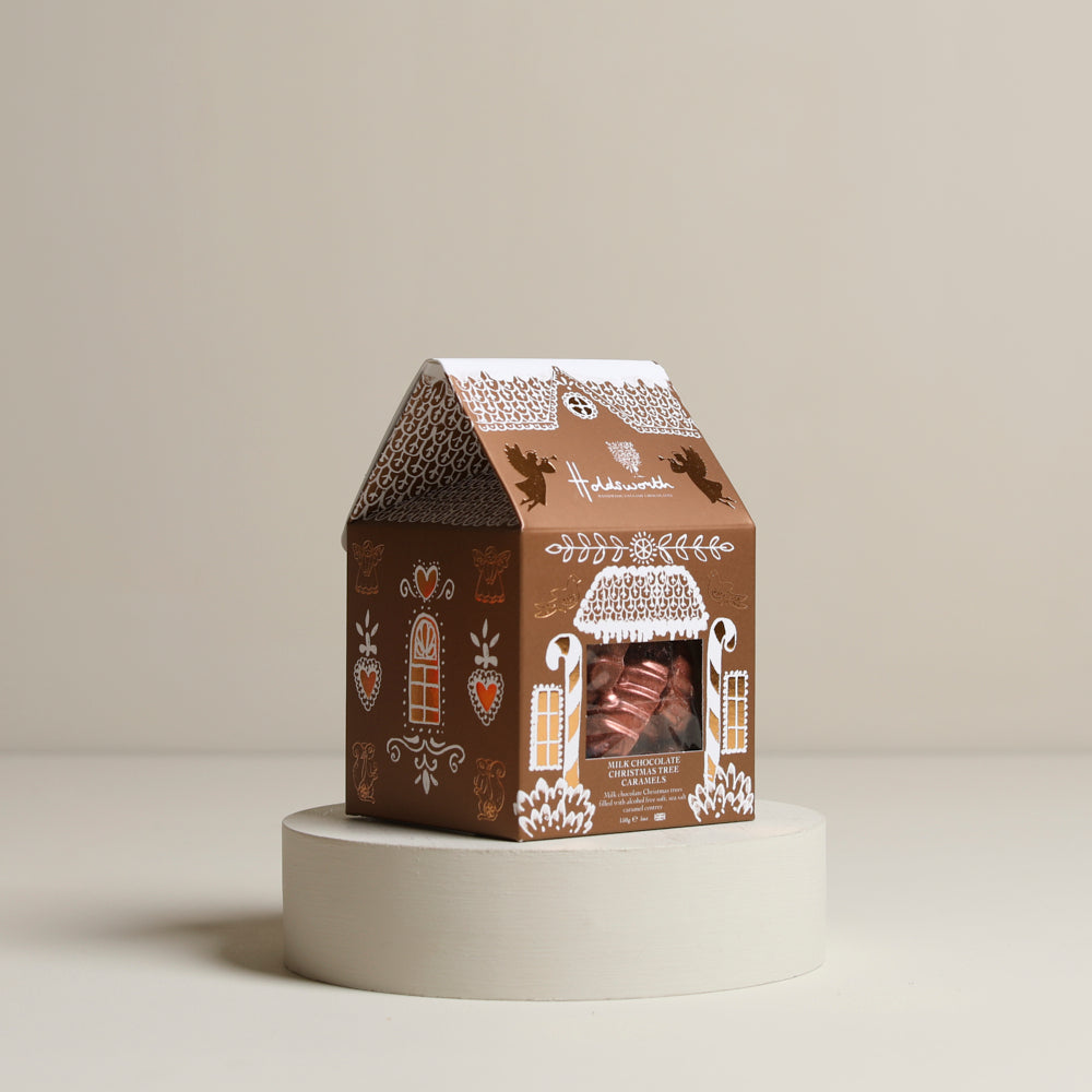 
                  
                    Gingerbread House with Christmas Tree Caramels
                  
                